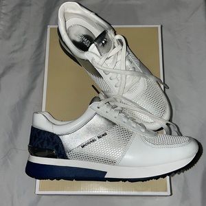 White, navy and silver Michael Kors tennis shoes.